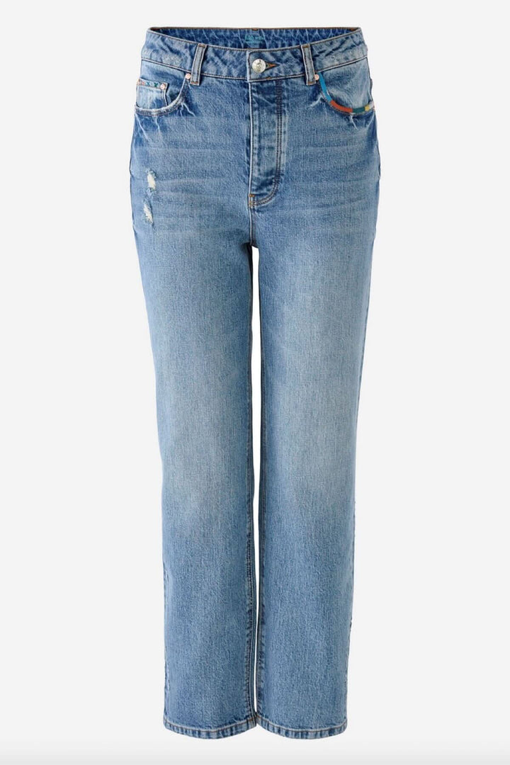 Jean pâle à jambe droite avec détails de coutures colorées, en 100% coton, idéal pour un style original.