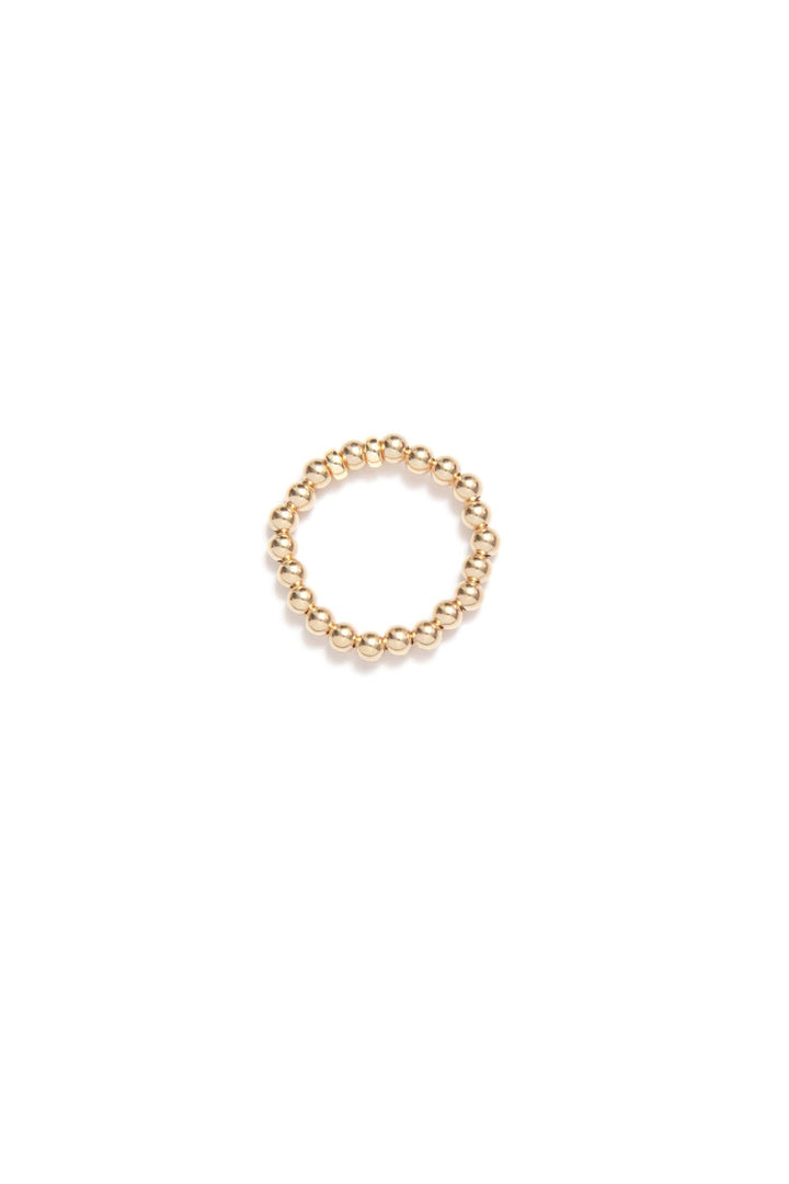 Bague élastique Be Timeless en or avec petites perles dorées, idéale pour un look raffiné et personnalisable.
