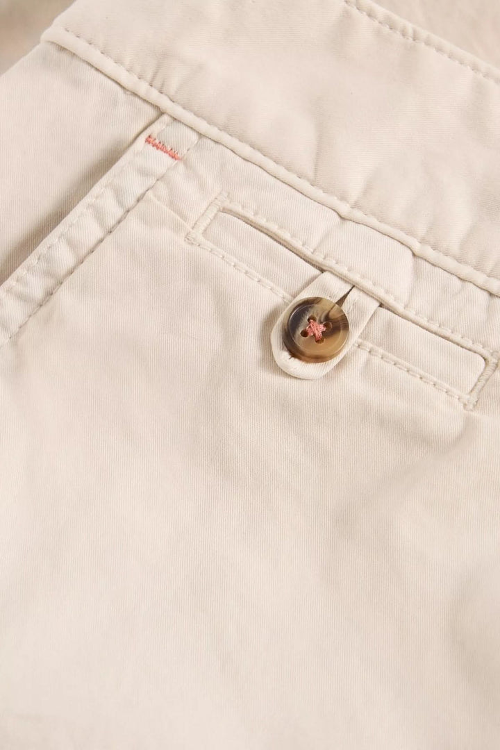 Zoomed view of Bermuda Hayley natural cotton shorts showing button closure and pocket detail.