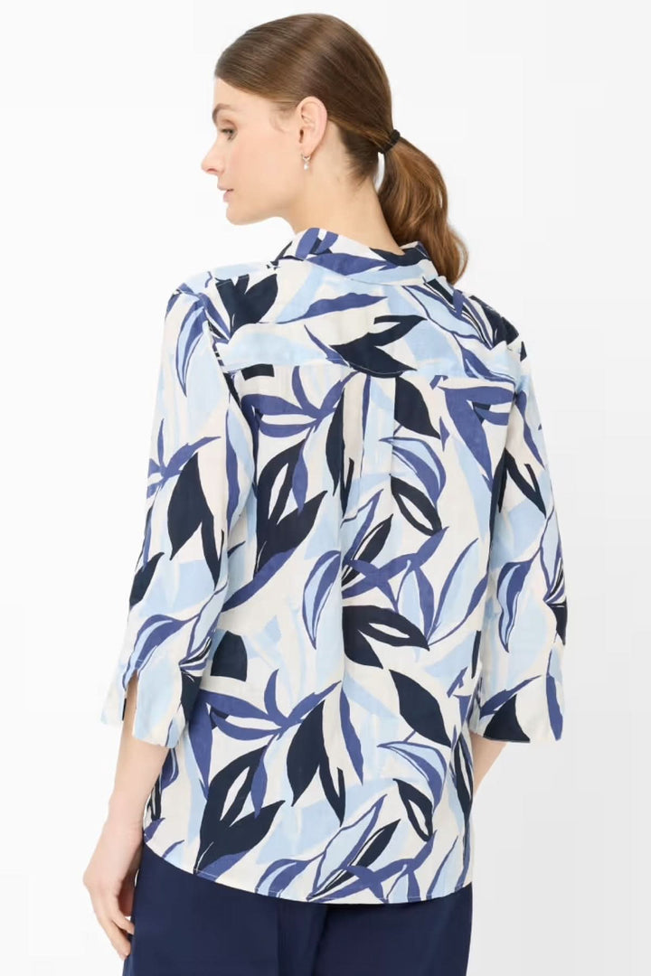 Femme portant la Blouse VICKI avec imprimé graphique, coupe ample et manches trois-quarts, vue de dos.