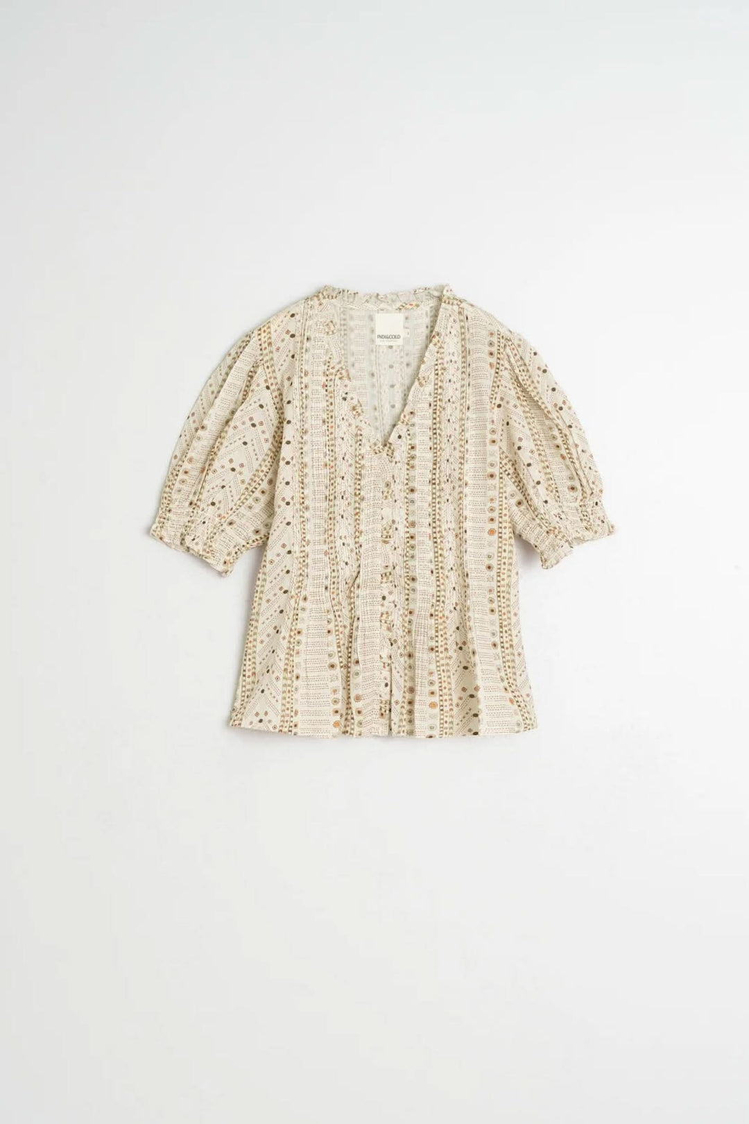 Blouse fluide imprimée à manches courtes avec encolure en V et manches bouffantes, parfaite pour un style décontracté ou habillé.