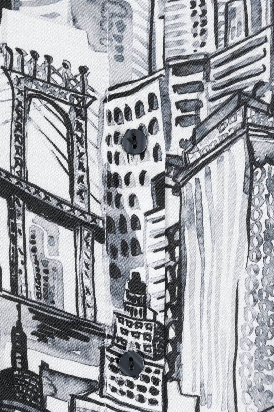 Imprimé graphique urbain en noir et blanc sur blouse, représentant des bâtiments et la skyline d&