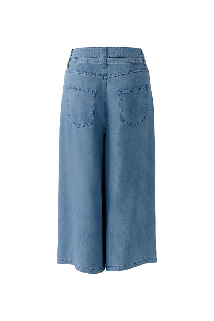 Capri denim à jambe large, coupe ample et longueur mi-mollet, avec taille à cordon, parfait pour un look décontracté soigné.