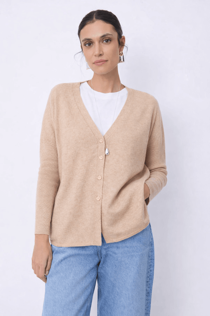 Cardigan en cachemire Alicia avec coupe droite et encolure en V, femme le portant avec un t-shirt blanc et un jean bleu clair.