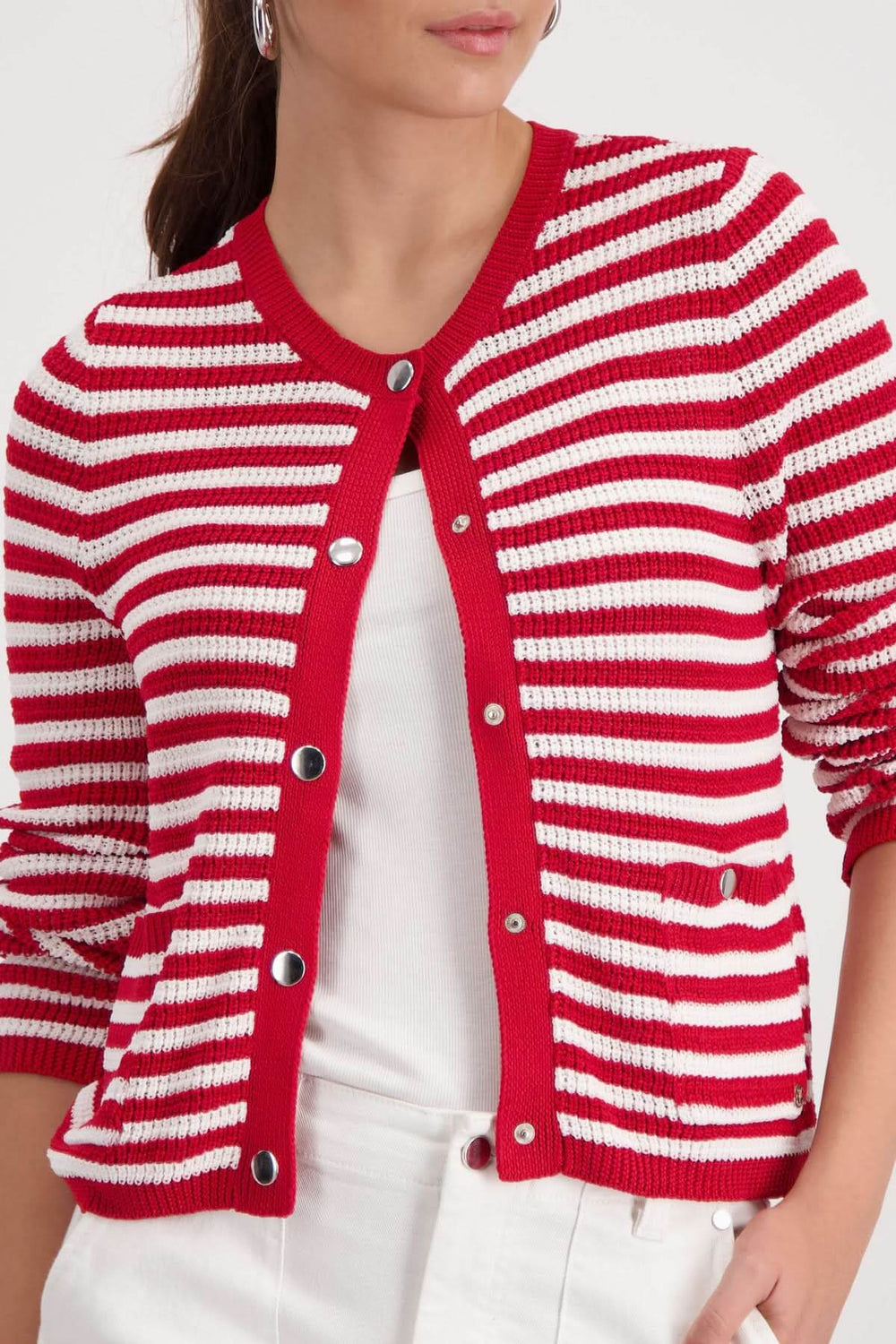 Cardigan rayé boutonné rouge et blanc, encolure arrondie, style structuré féminin, porté sur un haut blanc.