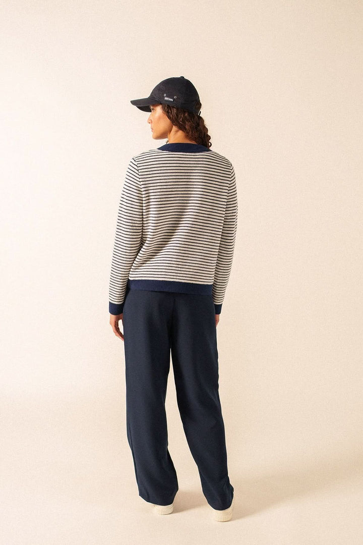 Person wearing Cardigan rayé style marin ISTRES, back view, showcasing nautical striped design, perfect for casual to refined outfits.