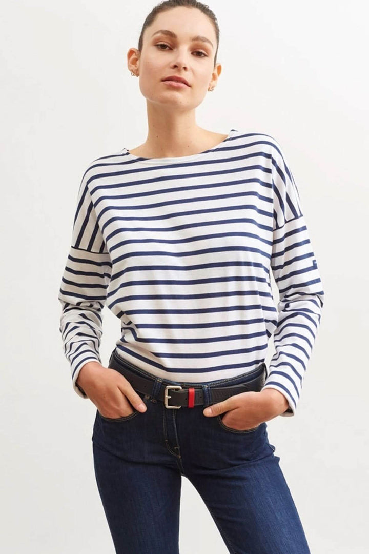 Modèle portant un chandail MINQ DROP II à rayures, style moderne et décontracté, associé à un jeans.