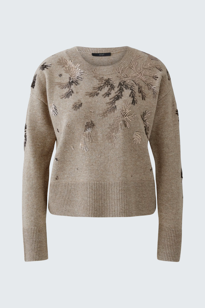 Chandail broderies beige à encolure ronde et coupe droite, motifs scintillants et confort doux, idéal avec jean ou jupe simple.