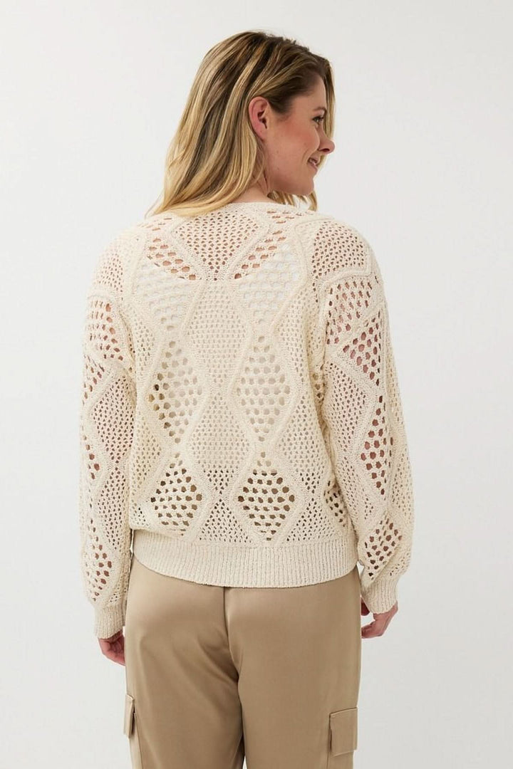 Chandail en crochet ajouré à motif géométrique et col en V, coupe ample et manches longues.