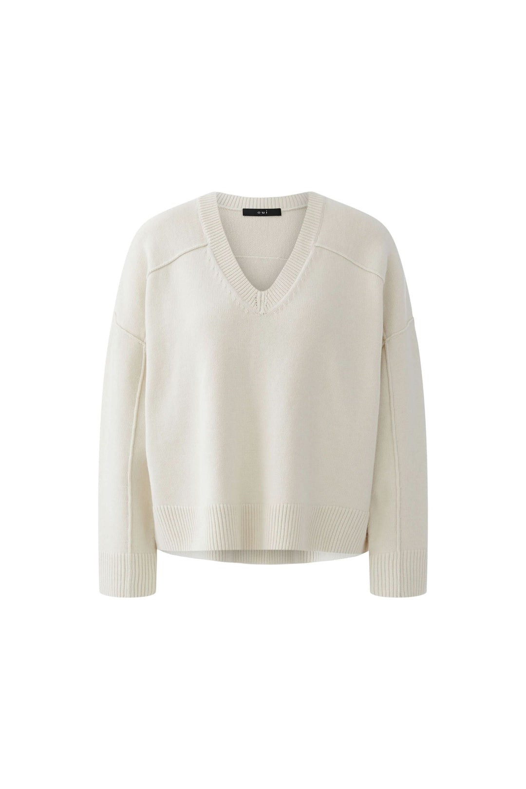 Chandail en maille à col en V couleur crème, manches longues, coupe ample, pour un look moderne et confortable.