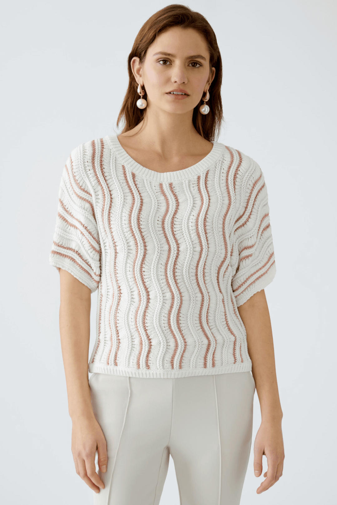 Chandail en maille texturée avec motif ondulé et manches courtes, col rond, look moderne et décontracté.