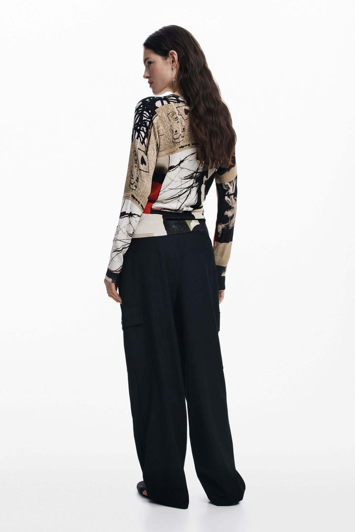 Vue arrière d'un pull à imprimé artistique avec manches longues et col rond, associé à un pantalon noir.
