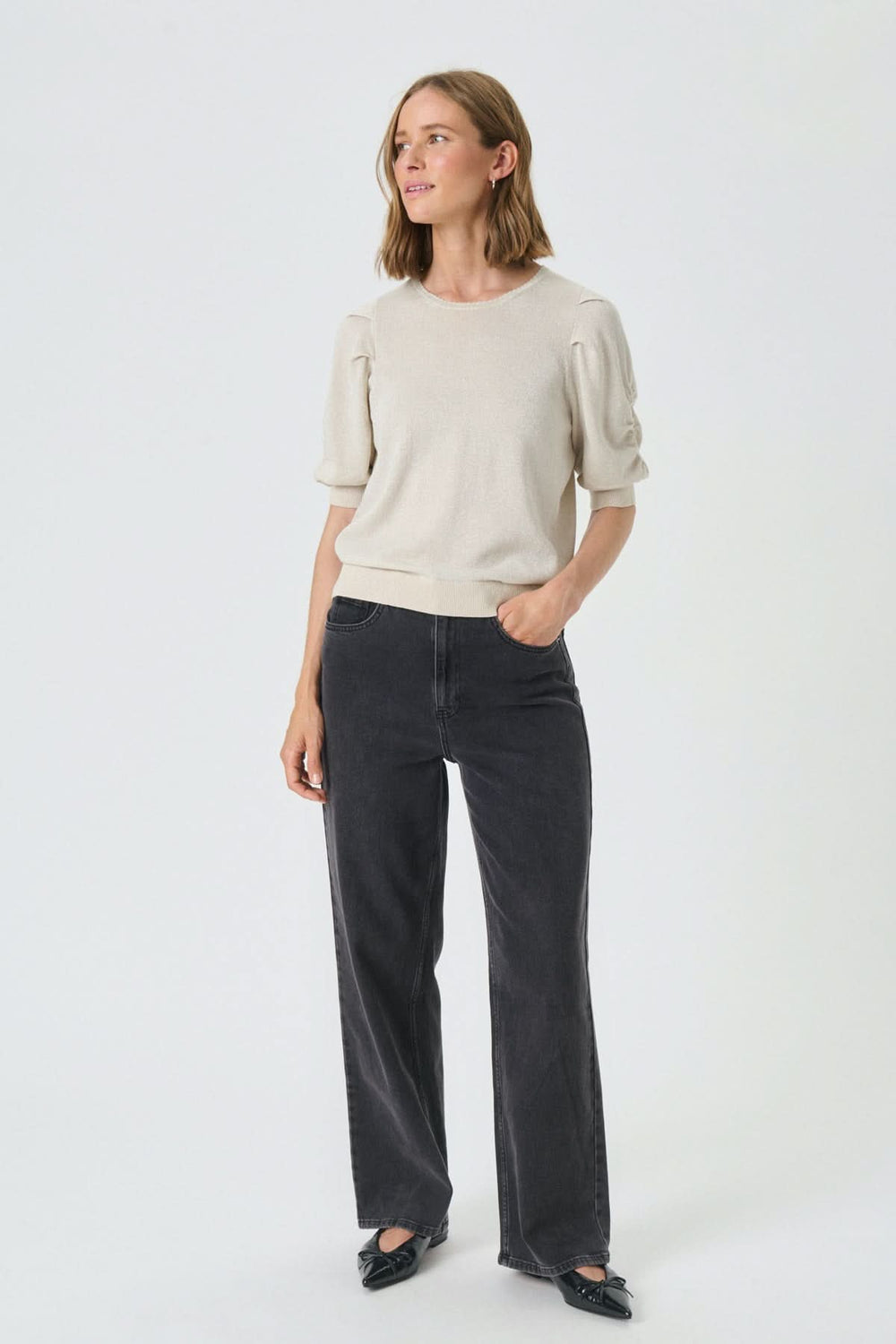 Femme portant le Chandail scintillant Varaia, parfait pour un style chic et confortable avec manches courtes et encolure ronde.