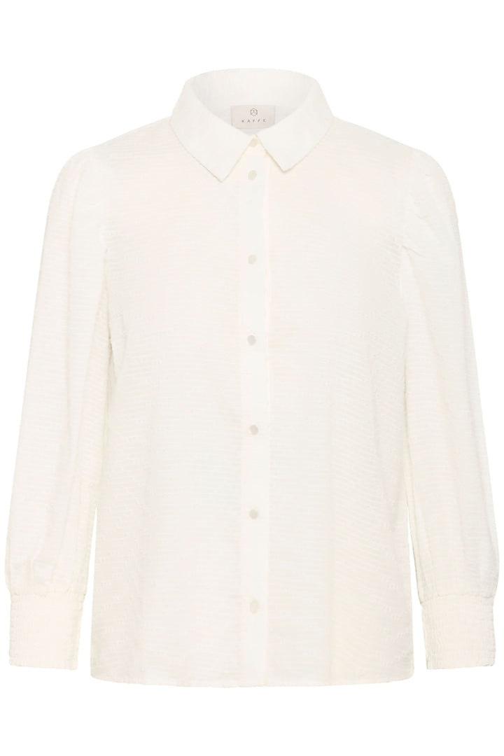 Chemise Penelope texturée à manches bouffantes avec col chemise et fermeture boutonnée, idéale pour un style moderne et délicat.