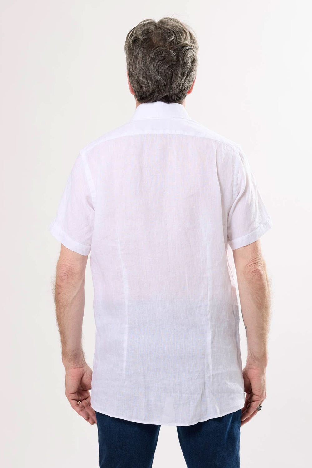 Chemise en lin blanche à manches courtes vue de dos, offrant confort et style pour l'été.
