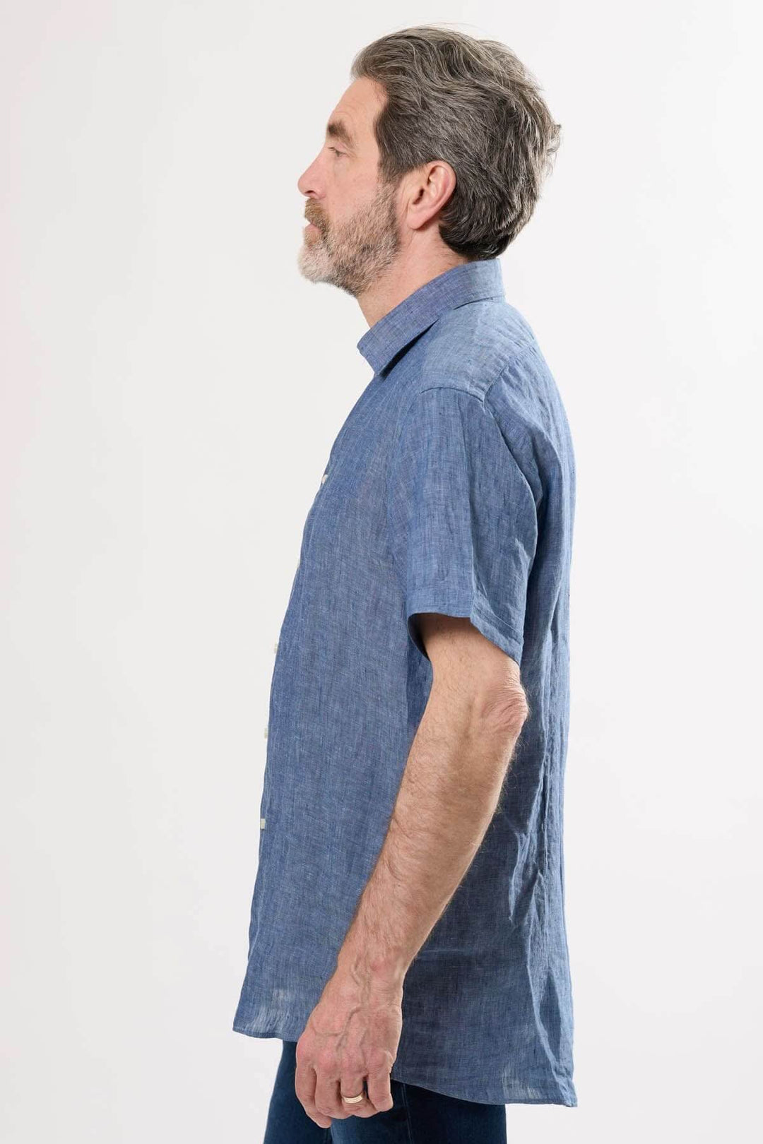 Chemise en lin bleu à manches courtes, profil latéral montrant le col classique et le tissu léger.