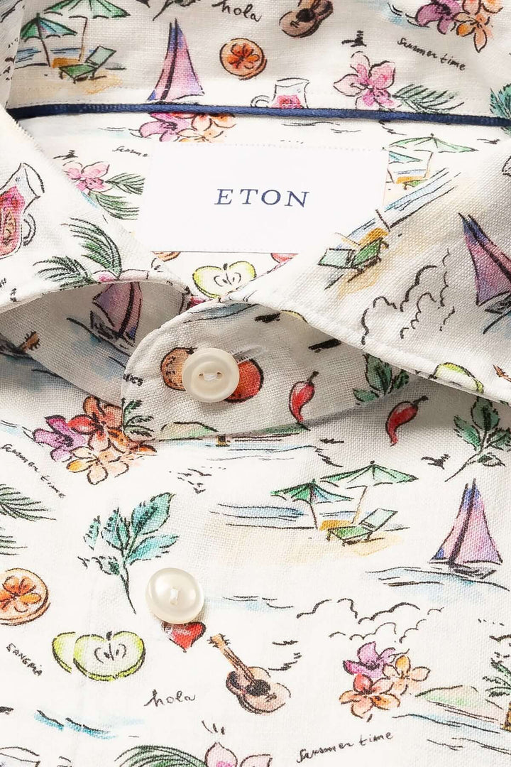 Chemise en lin Eton avec imprimé estival coloré de fleurs, fruits et plages, parfaite pour l'été.
