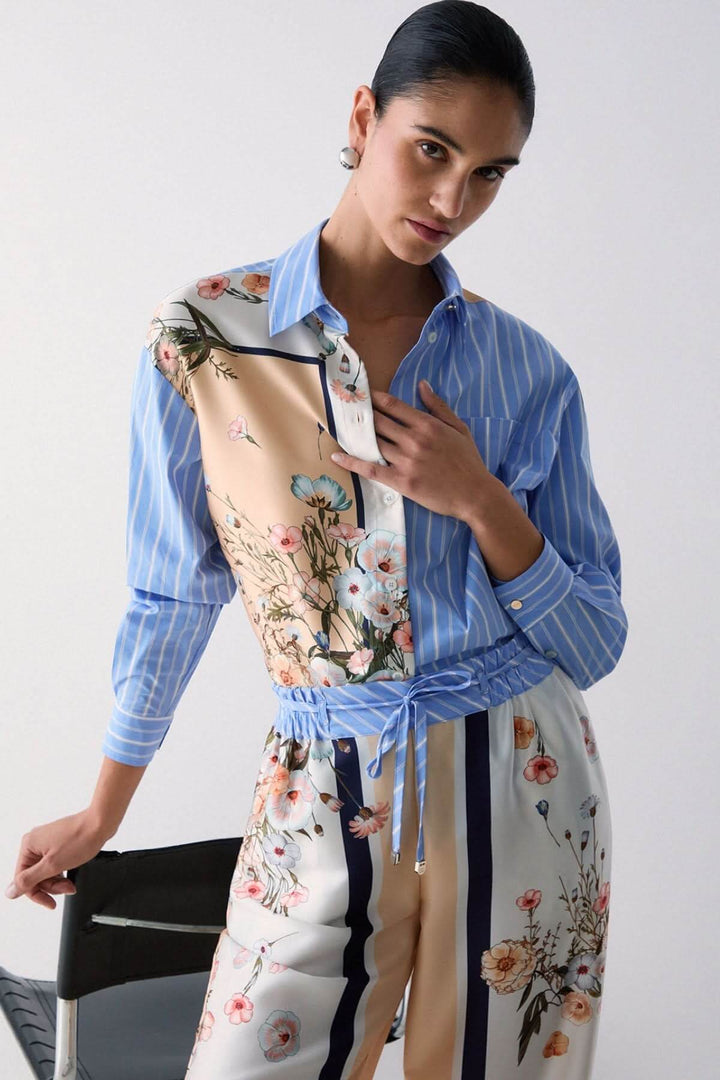 Chemise à manches longues avec motifs contrastés portée par une femme, montrant un design moderne avec rayures et motifs floraux.
