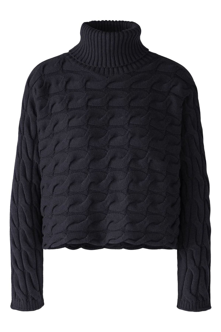 Col roulé en tricot torsadé noir à manches longues, parfait pour un look chic et moderne cet hiver.