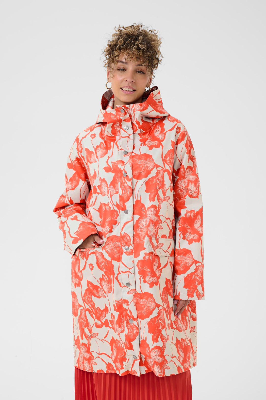Imperméable Olif avec motif floral et coupe droite, longueur sous le genou, porté par un mannequin, touche moderne et confortable.