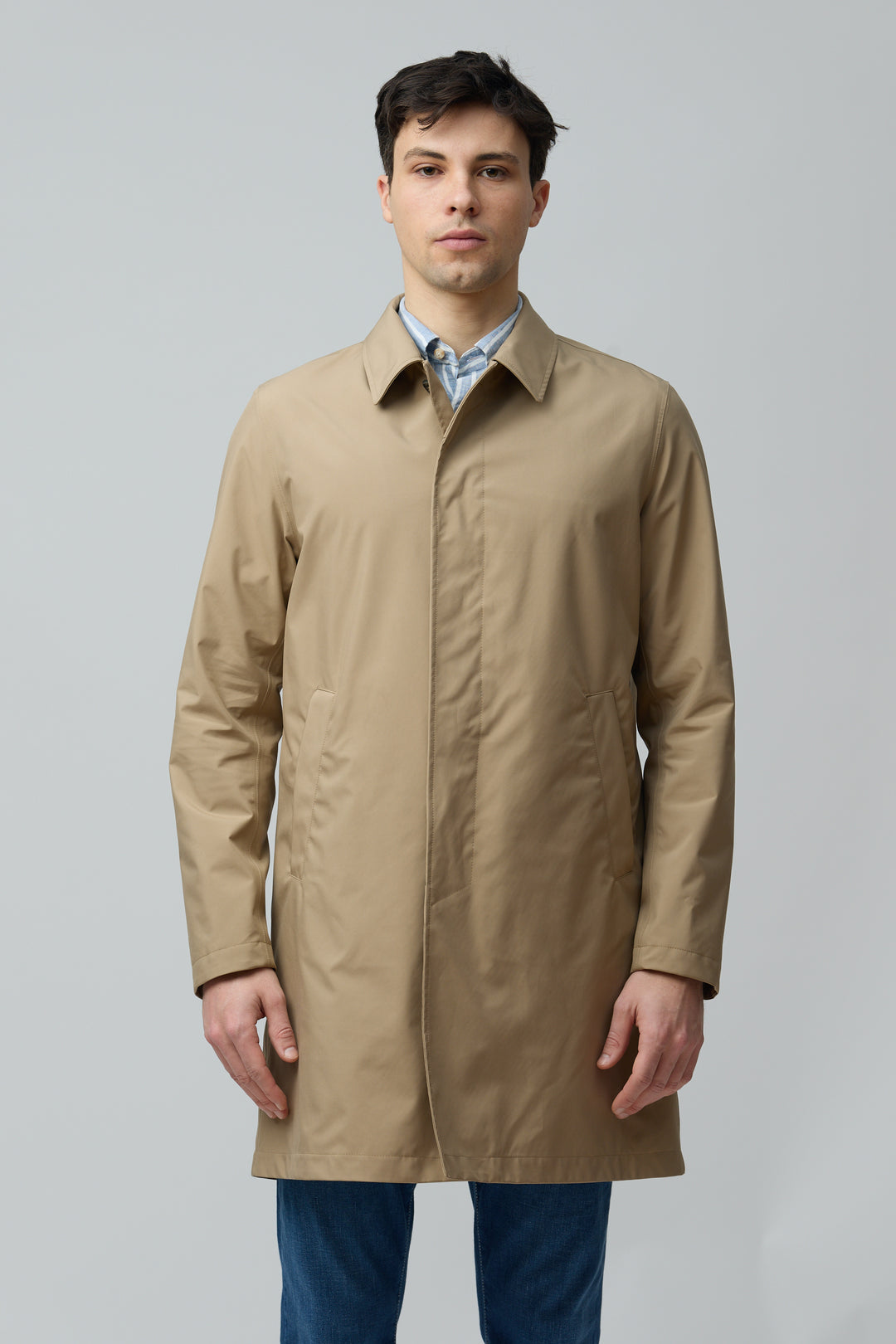 Homme portant un imperméable en microfibre technique avec col chemise et fermeture boutonnée, idéal pour l&
