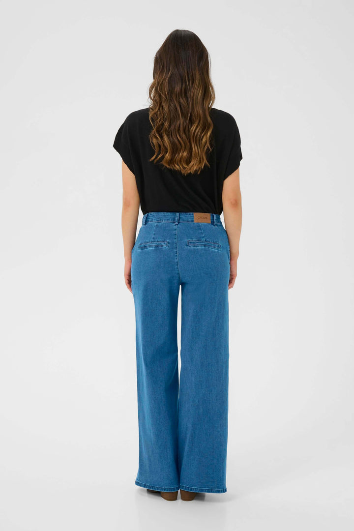 Jean à jambe large avec taille mi-haute, vue arrière, offrant confort et élégance pour un look moderne.