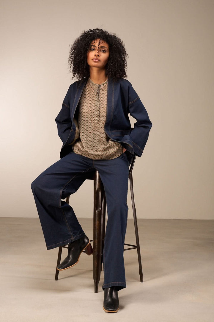 Femme portant un jean coupe large avec blouse ajustée, montrant un style décontracté chic.