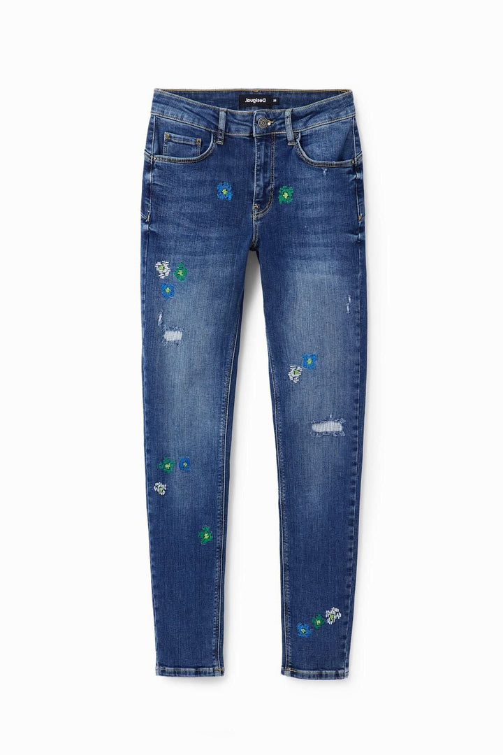 Jean skinny push-up avec broderies de fleurs, tissu stretch, déchirures, taille mi-haute, effet ajusté.