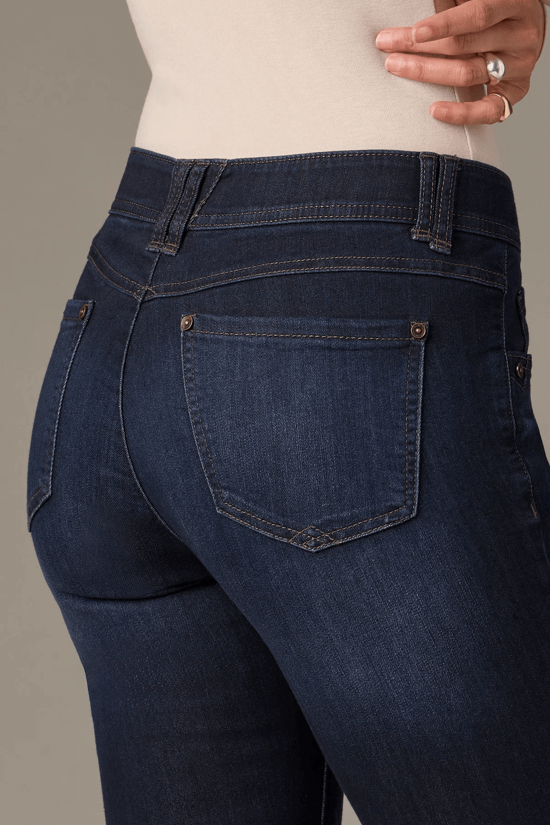 Detail of dark wash bootcut jeans highlighting the flattering fit and comfortable stretch fabric.