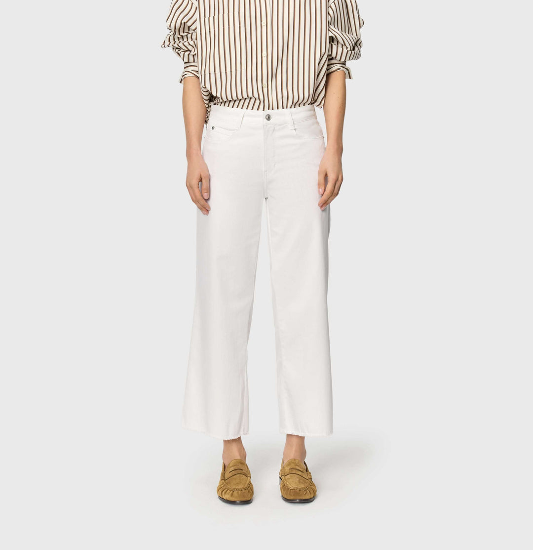 Jeans léger Dream wide cropped blanc à jambe large et taille mi-haute, porté avec une chemise rayée et des mocassins marron.