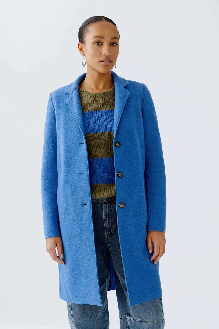 Manteau Mayson bleu, coupe droite, porté avec un chandail en maille, parfait pour un look chic et décontracté.