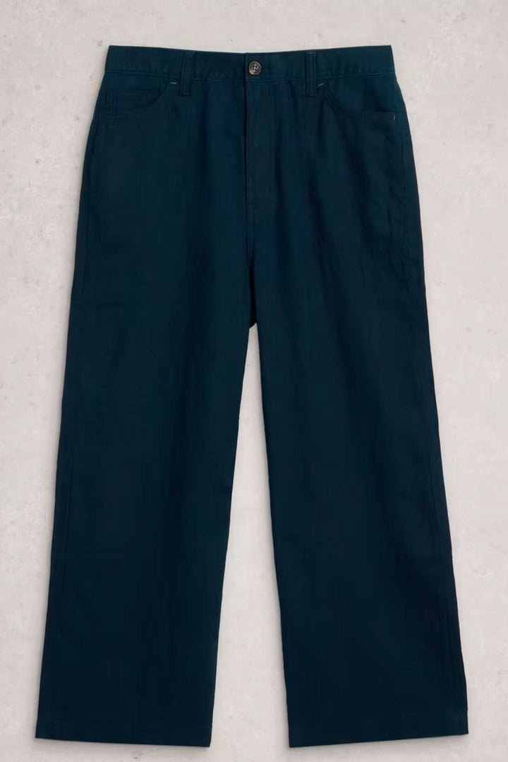 Pantalon Tia à jambes larges bleu avec coupe droite et poches latérales, idéal pour un look professionnel ou décontracté.