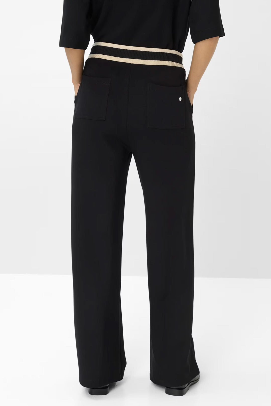 Pantalon noir coupe large avec ceinture élastiquée et détails contrastés au dos.