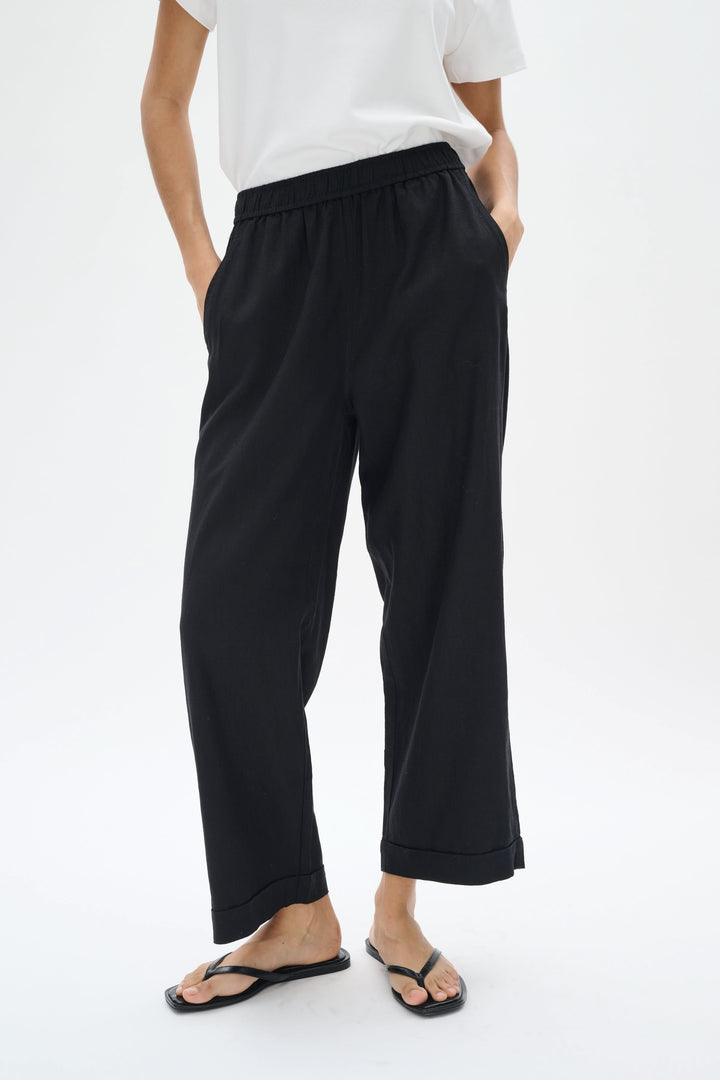 Pantalon en lin Rimona Driza, noir, avec taille élastique, jambes larges et poches latérales, style élégant et décontracté.