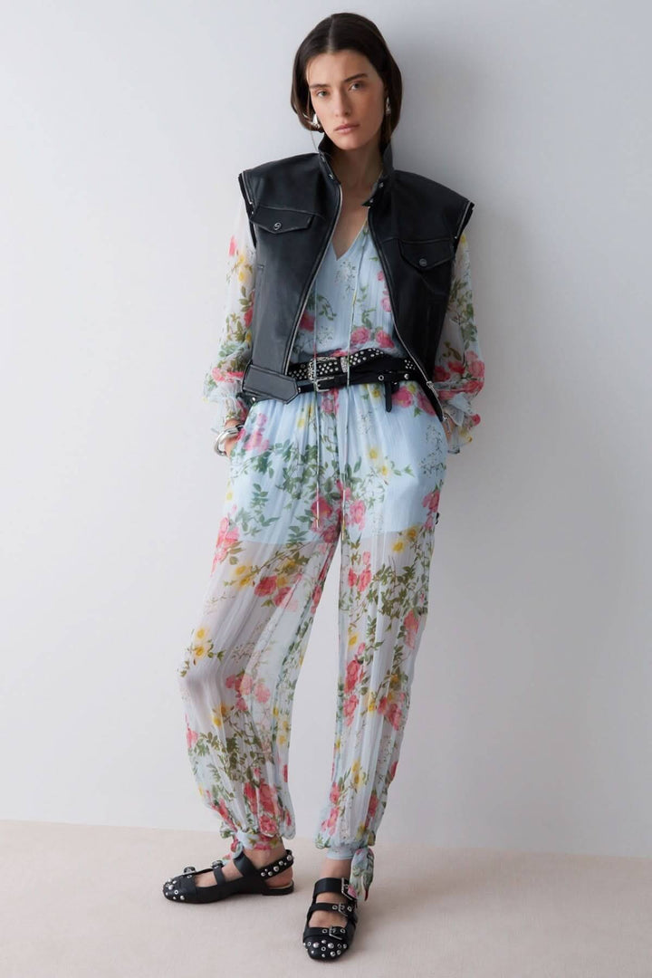 Pantalon fluide à imprimé floral avec taille élastique et ourlets noués, parfait pour un look estival élégant et féminin.