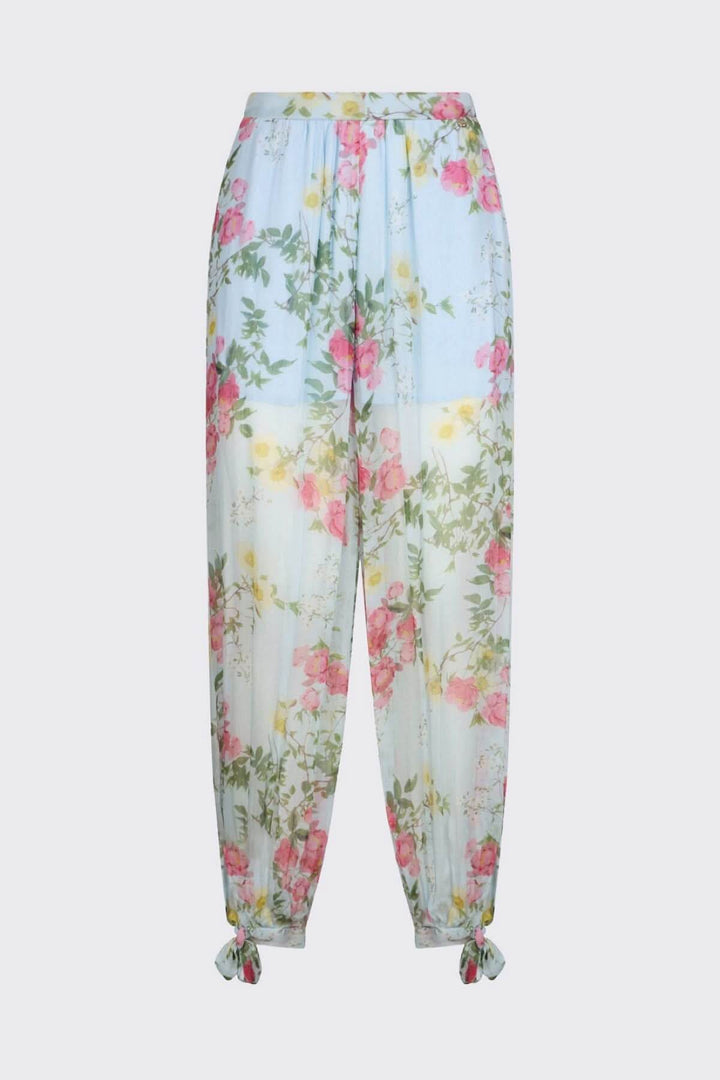 Pantalon fluide à imprimé floral avec jambes longues et ourlets noués, idéal pour un look estival élégant et féminin.