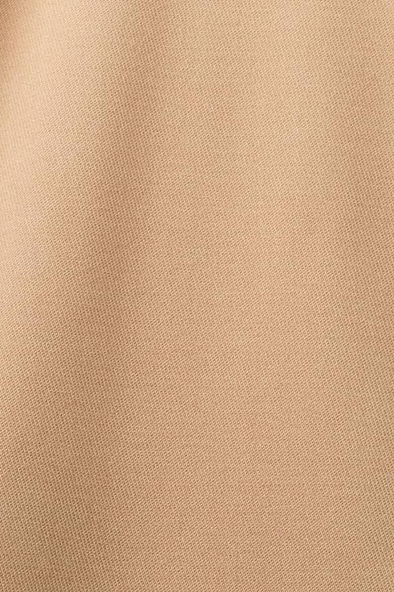 Tissu beige texturé utilisé pour les pantalons habillés, idéal pour le bureau et les événements spéciaux.