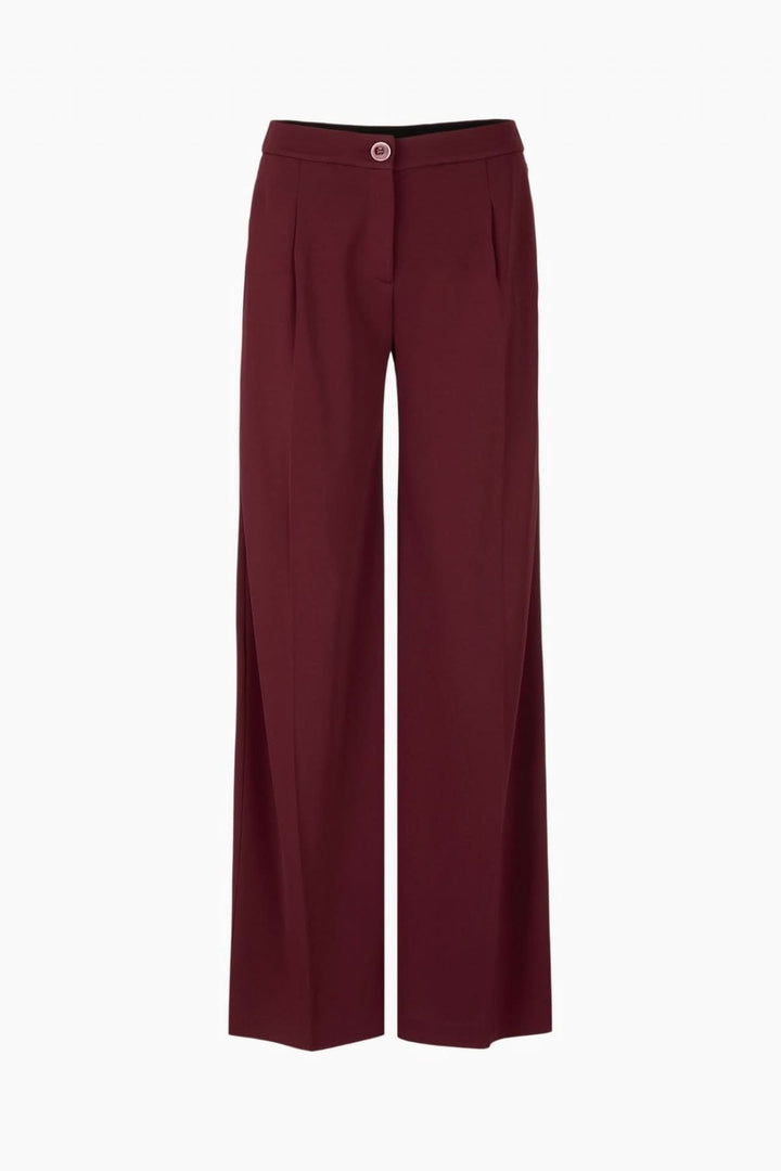 Pantalon jambes larges en tissu fluide, taille haute avec plis marqués pour une silhouette élégante.