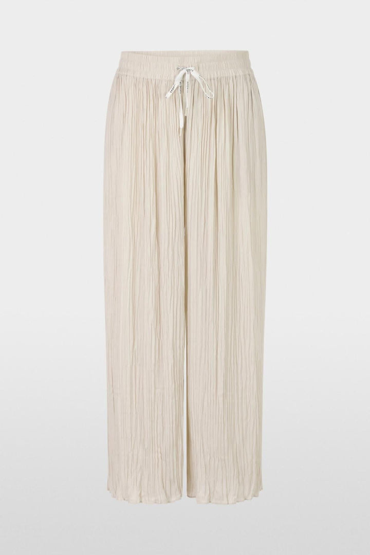 Pantalon large WOLIN en beige, fluide avec taille élastique et cordon, offrant confort et élégance.
