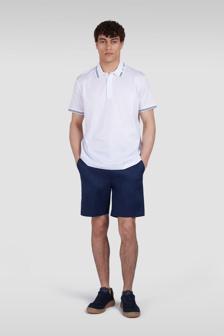 Homme portant un polo en coton avec col contrastant, coupe régulière, idéal pour une tenue estivale élégante.