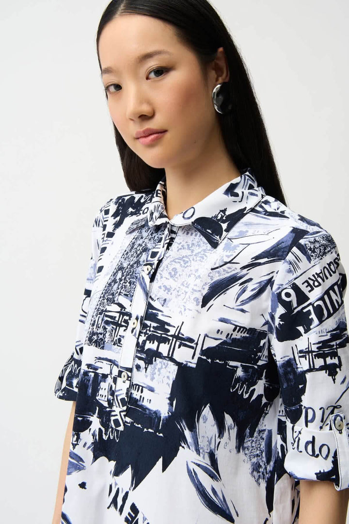 Femme portant une robe chemise imprimée avec un design graphique urbain et col structuré.