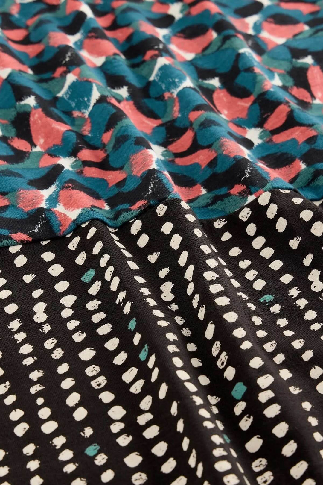 Tissu imprimé de la Robe à col V Tallie avec motifs graphiques colorés et modernes, parfait pour un look féminin et confortable.