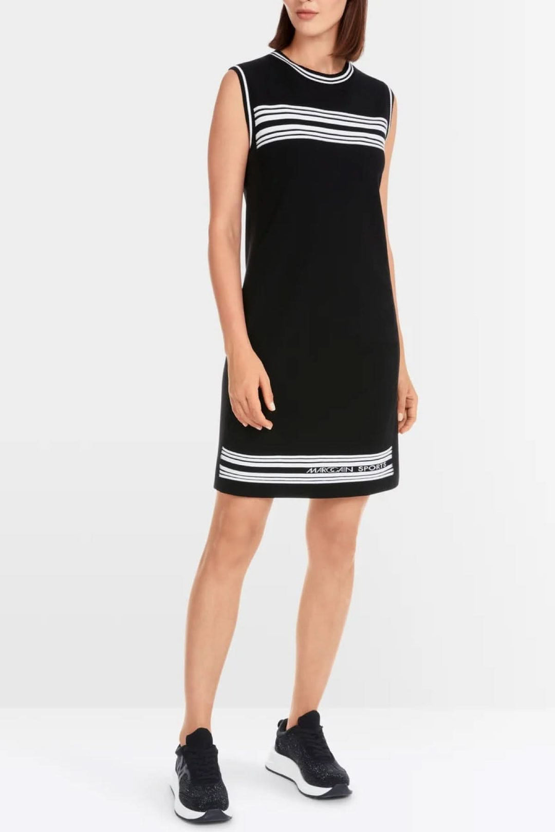 A black sleeveless A-line dress featuring striped borders, made from responsible materials and sustainably produced.