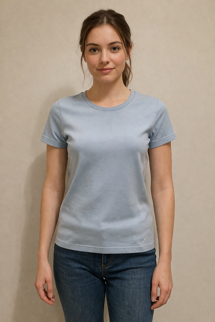 Femme portant un T-shirt AJACCIO II bleu clair, coupe ajustée, manches courtes, 100% coton, facile à coordonner avec sa gamme couleur.