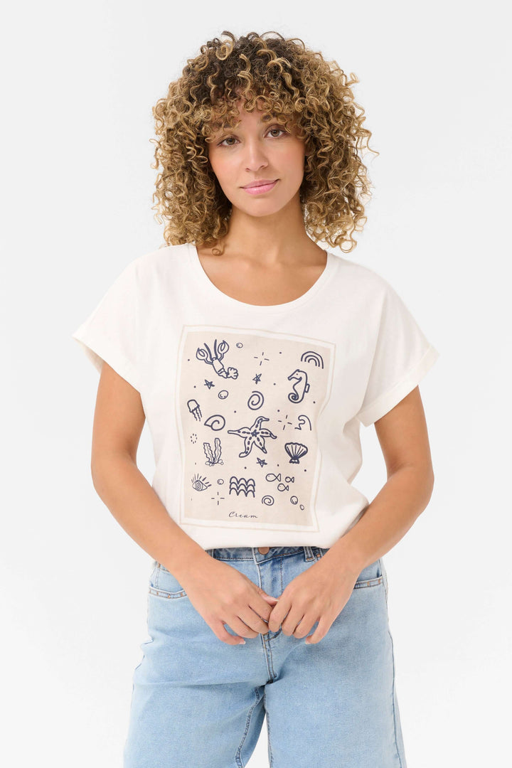 T-shirt Juka en coton avec imprimé graphique marin, coupe décontractée et manches retournées, style estival.