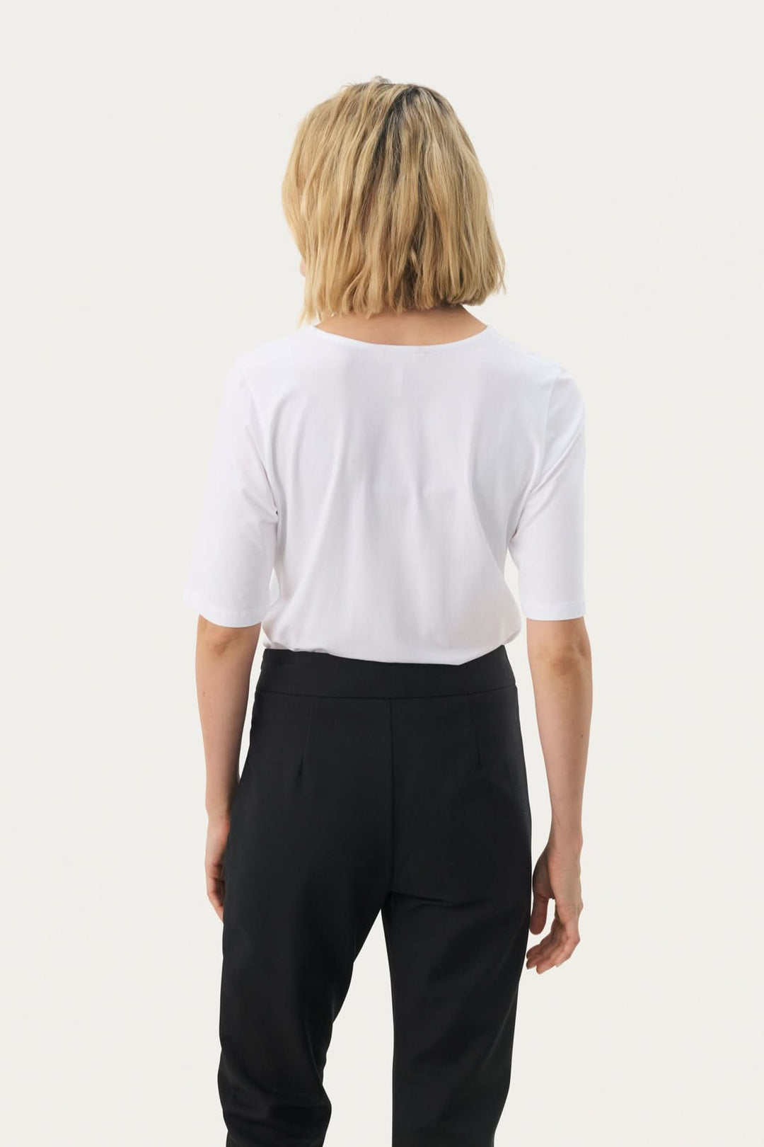 Femme portant un T-shirt coupe droite Nemi blanc, vue de dos, style épuré et confortable, tendance moderne.