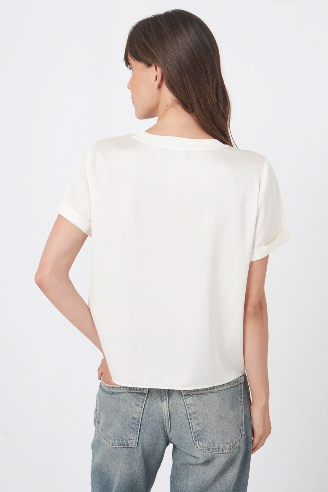 Femme portant un t-shirt en soie fluide et extensible, vu de dos, avec des manches courtes et une coupe élégante.