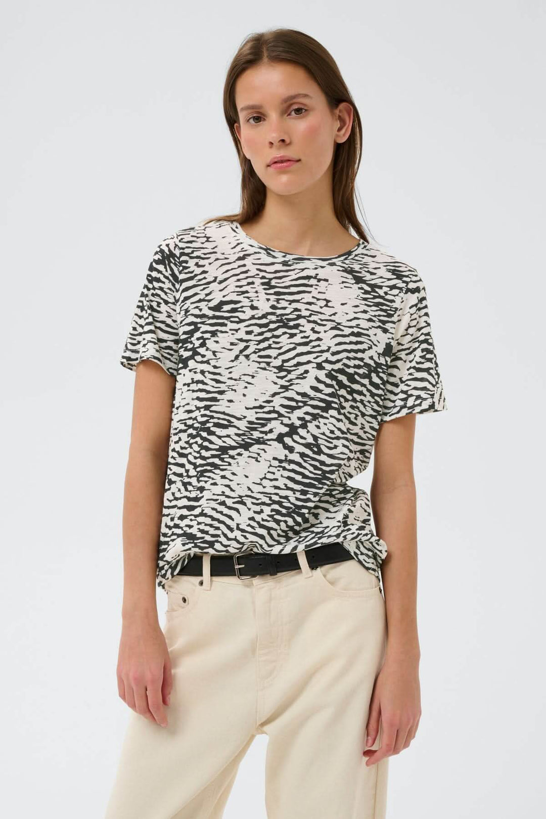 Femme portant un T-shirt imprimé Alma avec coupe droite et imprimé graphique, style décontracté et actuel, manches courtes.