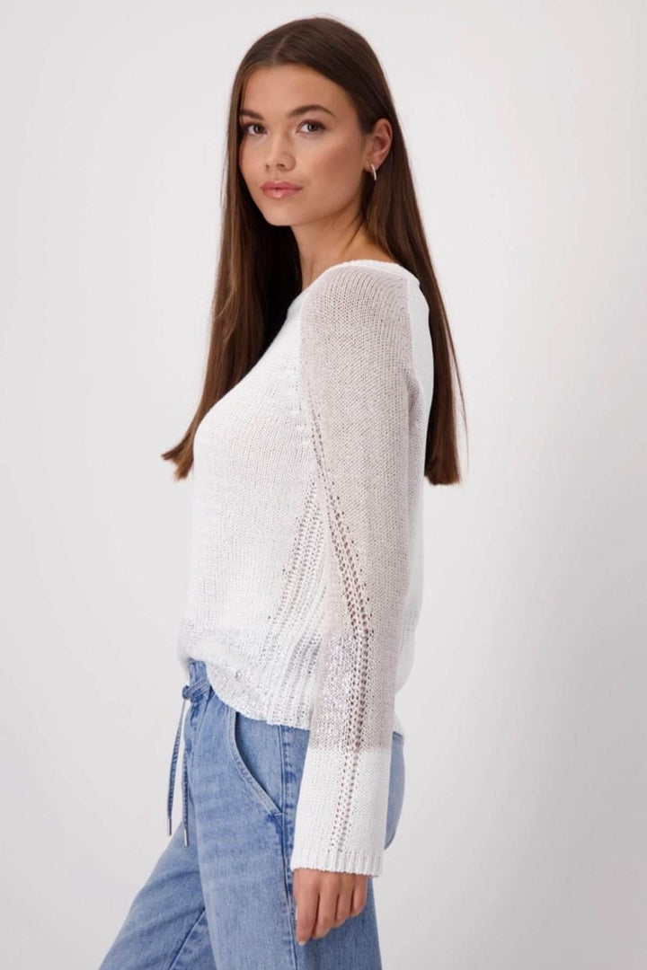 Model wearing a chic white color block knit sweater with a modern design and relaxed fit.