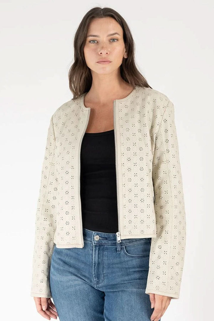Hillary perforated leather jacket with delicate cut-out pattern and structured fit, styled with jeans.